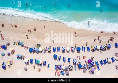 Egremni Beach Lefkada tourists relaxing on the beach, swimming and playing games on a hot summer day Stock Photo