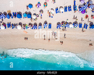 Tourists relaxing on the Egremni Beach in Lefkada swimming and playing games in the water Stock Photo