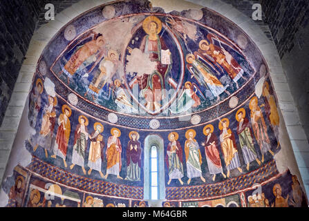 Interior Byzantine Romanesque style Christian frescoes of the central apse with Christ Pantocrator (in majesty) in a maodorla, Santissima Trinita di S Stock Photo