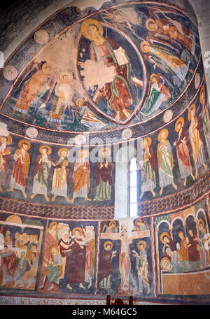 Interior Byzantine Romanesque style Christian frescoes of the central apse with Christ Pantocrator (in majesty) in a maodorla, Santissima Trinita di S Stock Photo