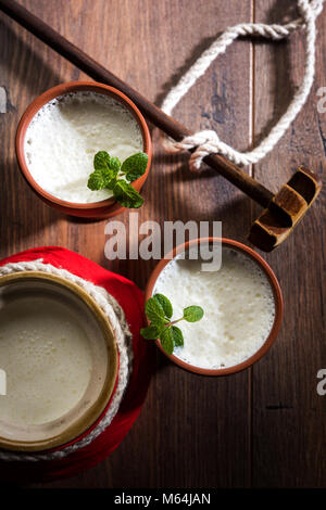 Lassie or lassi in terracotta glass - Lassi is an Authentic Indian cold drink made up of curd and milk and sugar, selective focus Stock Photo