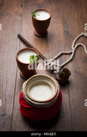 Lassie or lassi in terracotta glass - Lassi is an Authentic Indian cold drink made up of curd and milk and sugar, selective focus Stock Photo