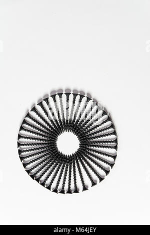 Photoset patterns arranged from black screws isolated on a white background in the form of a circle and a heart Stock Photo