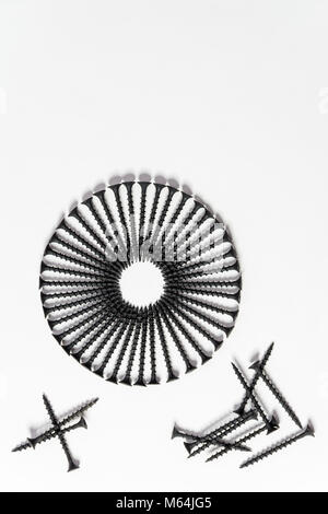 Photoset patterns arranged from black screws isolated on a white background in the form of a circle and a heart Stock Photo