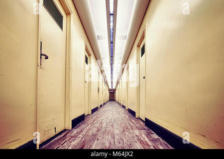 Empty corridor in an old building, color toned picture. Stock Photo