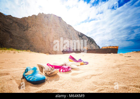 Trash left at Navagio beach, with Panagiotis shipwreck in back. Zakynthos, Greece. Artistic view. Stock Photo