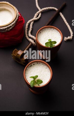 Lassie or lassi in terracotta glass - Lassi is an Authentic Indian cold drink made up of curd and milk and sugar, selective focus Stock Photo