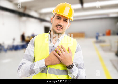 Industrial factory manager suffering chest heart pain or cardio problem because of stress and many working hours Stock Photo