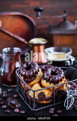 Marble mini bundt cakes with chocolate frosting on dark background Stock Photo