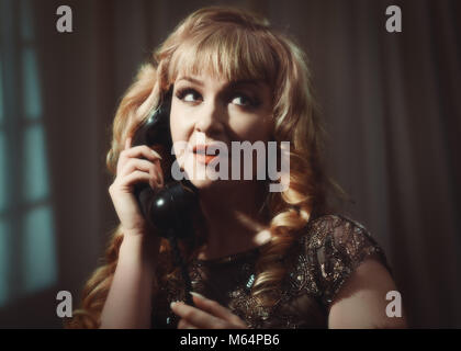 Woman on vintage telephone with cinematic style tone Stock Photo