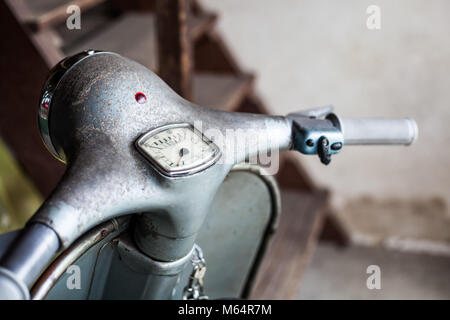 Handlebar with speedometer and switch of barn find old, rusty blue-grey original paint italian motorbike scooter Stock Photo