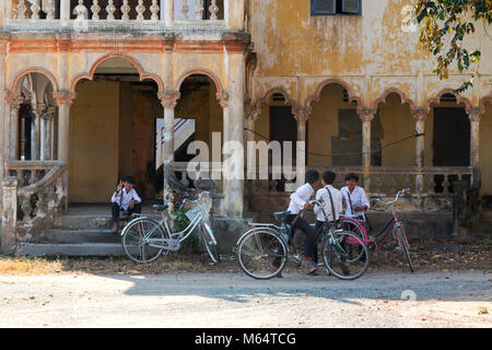 Children playing outside an old french colonial building, Angkor Borei, Kampot province Cambodia Asia Stock Photo