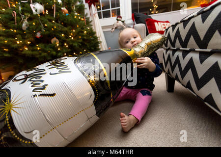 A Caucasian Boy and Girl Enjoy New Years Eve Together in Their Suburban Home Living Room Stock Photo