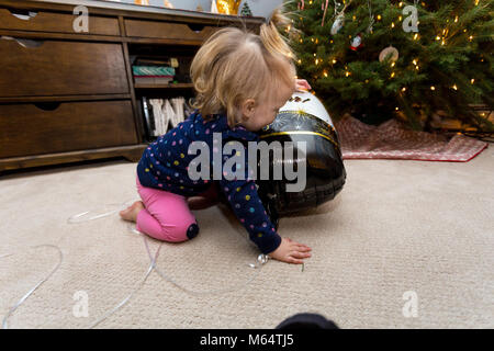 A Caucasian Boy and Girl Enjoy New Years Eve Together in Their Suburban Home Living Room Stock Photo