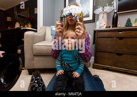 A Caucasian Boy and Girl Enjoy New Years Eve Together in Their Suburban Home Living Room Stock Photo