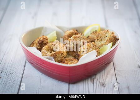 Oven baked squid (calamari) Rings in a healthy Panko & Coconut coating Stock Photo
