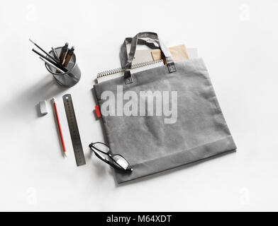Gray shopping canvas bag and stationery on white paper background. Stock Photo