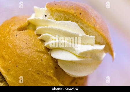 Swedish Semla – a small, wheat flour bun, flavoured with cardamom and filled with almond paste and whipped cream  Model Release: Yes/No. Property Release: Yes/No. Stock Photo