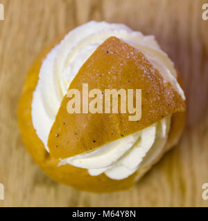 Swedish Semla – a small, wheat flour bun, flavoured with cardamom and filled with almond paste and whipped cream  Model Release: Yes/No. Property Release: Yes/No. Stock Photo