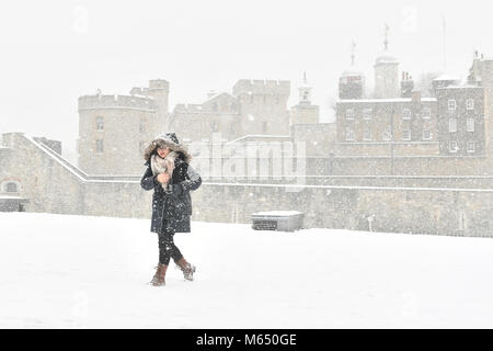 A woman by the Tower of London in snowy conditions, as the highest level of weather warning has been issued for Scotland and Ireland as forecasters warn of blizzard-like conditions. Stock Photo