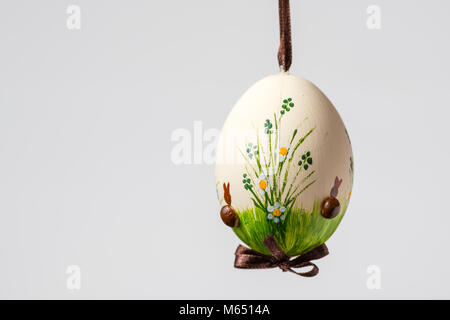 Closeup of a beautiful hand painted easter egg hanging on a brown string Stock Photo