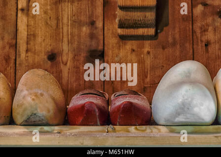 wooden clogs in a row lying on a shelf Stock Photo