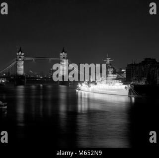 HMS Belfast, the veteran World War II cruiser moored in the Thames, near Tower Bridge, is now floodlit. A new floodlighting system donated by Philips Electrical Limited was officially switched on last night by Reg Prentice, Secretary of State for Education and Science, to form part of the European Architectural Heritage Year. Stock Photo