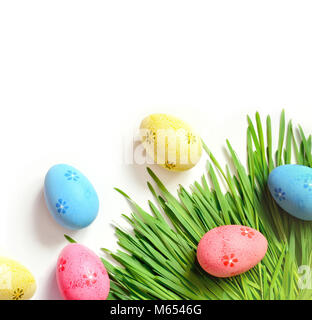 Painted Easter eggs on green grass isolated on white. Flat lay. Happy Easter. Stock Photo