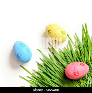 Painted Easter eggs on green grass isolated on white. Flat lay. Happy Easter. Stock Photo