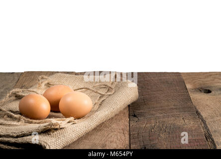 Freshly laid organic eggs on wooden bench Stock Photo