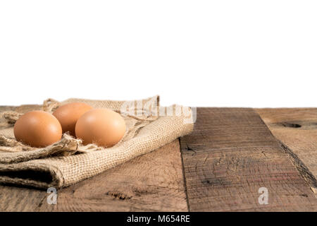Freshly laid organic eggs on wooden bench Stock Photo