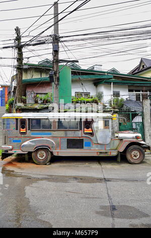 Filipino grey-silvery dyipni-jeepney. Public transport in Baguio town-originally made from US.military cars left over from WW.II locally altered-now f Stock Photo