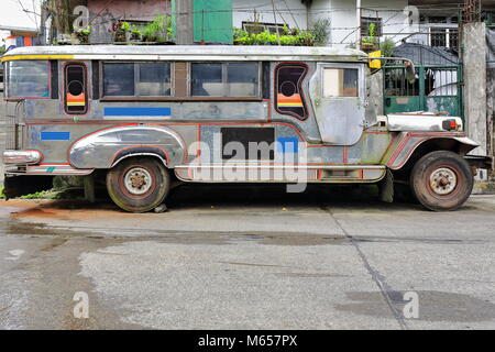 Filipino grey-silvery dyipni-jeepney. Public transport in Baguio town-originally made from US.military cars left over from WW.II locally altered-now f Stock Photo