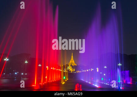 Public Square People's Park with lit illuminated water fountains and Shwedagon Pagoda, Yangon, Myanmar (Burma), Asia in February Stock Photo