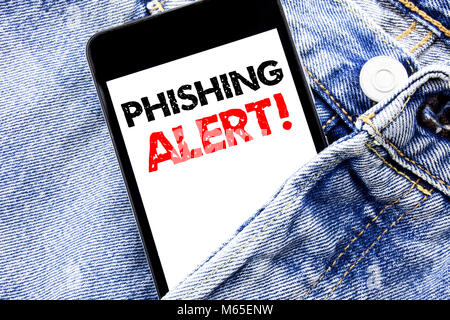 Hand writing text caption inspiration showing Phishing Alert. Business concept for Fraud Warning Danger Written phone mobile phone, cellphone placed i Stock Photo