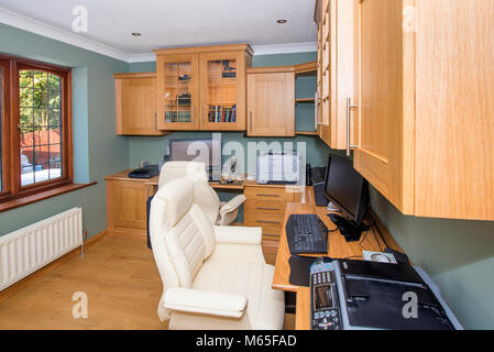 home office or study showing furniture, desks, computers, printers and chairs Stock Photo