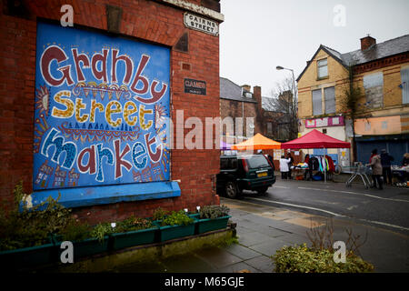 Liverpool's Granby Street market a  Turner Prize winning regeneration area. A boarded up house window makes the perfect  hand painted advert Stock Photo