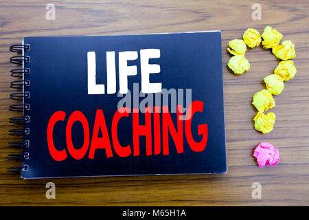 Handwritten text showing Life Coaching. Business concept writing for Personal Coach Help Written on notepad paper, wooden background in office view wi Stock Photo