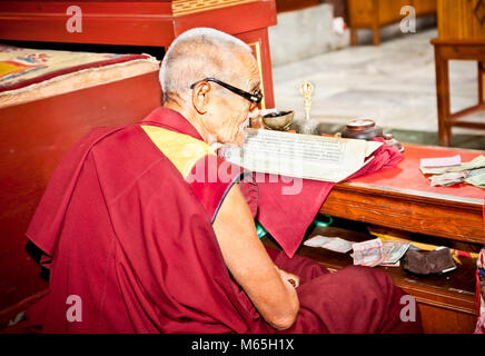 KATHMANDU, NEPAL - MAY 18: Unidentified buddhist monk is reading mantra in Bouddanath Stupa on May 18, 2013 in Kathmandu, Nepal. Stock Photo