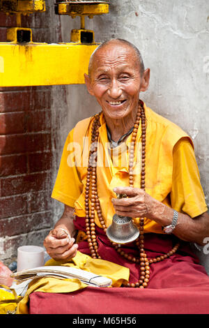 KATHMANDU, NEPAL - MAY 18: Unidentified buddhist monk is praying in Bouddanath Stupa on May 18, 2013 in Kathmandu, Nepal. Stock Photo