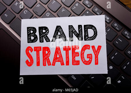 Word, writing Brand Strategy. Business concept for Marketing Idea Plan written on sticky note paper on dark keyboard background. Stock Photo