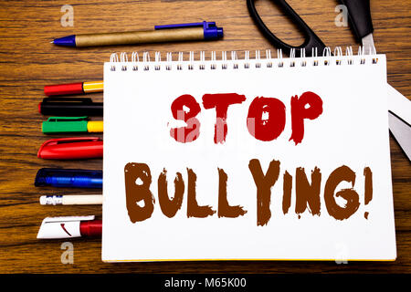Word, writing Stop Bullying. Business concept for Prevention Problem Bully Written on notebook, wooden background office equipment like pens scissors  Stock Photo