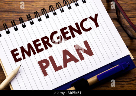 Hand writing text caption inspiration showing Emergency Plan. Business concept for Disaster Protection Written on notebook paper, wooden background wi Stock Photo