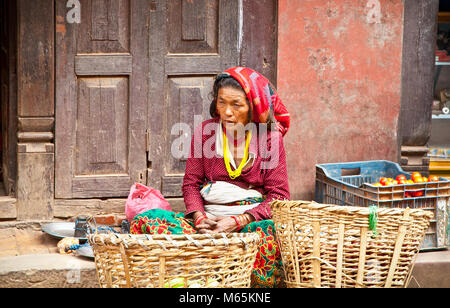 BHAKTAPUR, NEPAL - MAY 20: Woman sell fruits on a street market in Bhaktapur,Nepal, on May 20, 2013. On United Nations list Nepal as one of the Least  Stock Photo