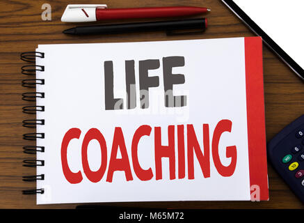 Handwritten text showing Life Coaching. Business concept writing for Personal Coach Help Written on notepad paper, wooden background in office view wi Stock Photo