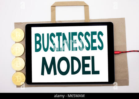 Handwritten text showing Businesses Model. Business concept writing for Project For Business Written on shopping bag and tablet white background, tabl Stock Photo