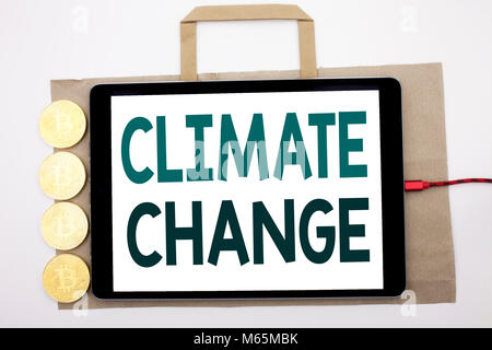Handwritten text showing Climate Change. Business concept writing for Global Planet Warming Written on shopping bag and tablet white background, table Stock Photo