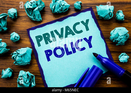 Writing text showing Privacy Policy. Business concept for Safety Data Rules Written on sticky note paper, wooden background marker folded yellow paper Stock Photo