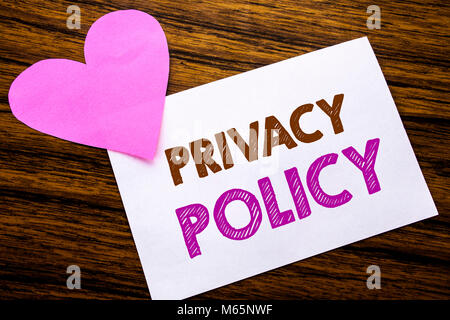Conceptual hand writing text showing Privacy Policy. Concept for Safety Data Rules written on sticky note paper, wooden background. With pink heart me Stock Photo