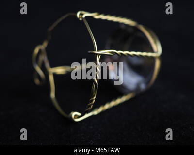 Muselet from bottle of champagne. Isolated on black background. Selective focus. Macro Stock Photo